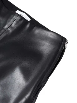 Pantalon noir uni avec une coupe skinny et un zip sur le côté