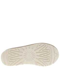 Pantoufles tasman en cuir beige avec logo iconique embossé sur le côté