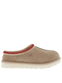 Pantoufles tasman en cuir beige avec logo iconique embossé sur le côté