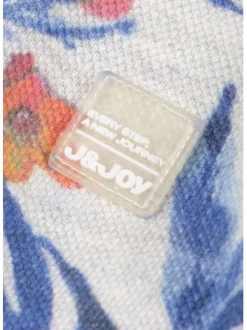 Polo blanc en coton maille piquée avec imprimé feuilles tropicales all-over coupe droite