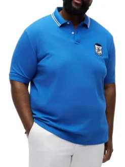 Polo en coton biologique bleu uni pourvu d'un col boutonné et de manches courtes