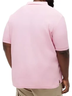 Polo en coton biologique rose uni pourvu d'une coupe droite et d'un col boutonné