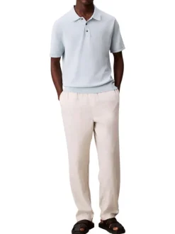 Polo en coton bleu ciel uni à coupe légèrement oversize avec le logo brodé