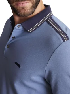 Polo en coton bleu uni à coupe slim avec un col à revers fermé par des pressions