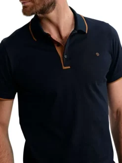 Polo en coton marine uni pourvu de manches courtes et d'un col boutonné