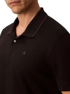 Polo en coton noir à coupe droite pourvu d'un col à revers boutonné