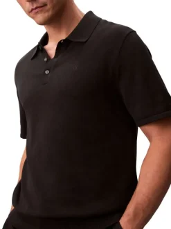 Polo en coton noir à coupe droite pourvu d'un col à revers boutonné