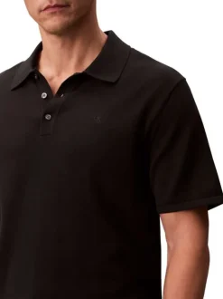 Polo en coton noir à coupe droite pourvu d'un col à revers boutonné
