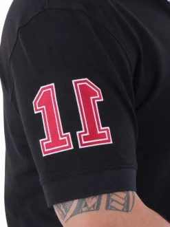 Polo en coton noir uni avec une coupe droite et logo iconique