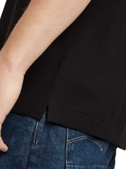 Polo en coton noir uni avec une coupe droite et un col boutonné