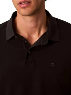 Polo en coton noir uni coupe ajustée et un col à revers boutonné