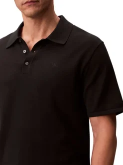 Polo en coton noir uni à coupe légèrement oversize avec le logo brodé