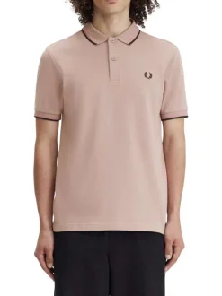 Polo en coton rose uni avec un col à deux boutons roses et une coupe droite