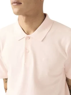 Polo en coton rose uni avec une coupe droite et un col boutonné