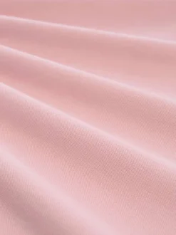 Polo en coton rose uni pourvu d'un col boutonné et de manches courtes