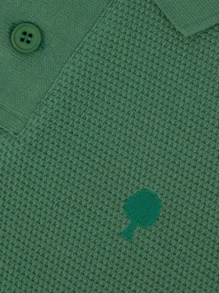 Polo en coton vert uni avec un logo brodé et un col boutonné