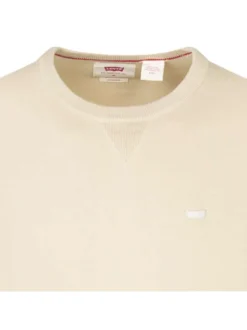 Pull beige uni avec une coupe droite à col rond et logo iconique