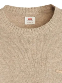 Pull beige uni en laine avec un col rond et logo de la marque sur la poitrine
