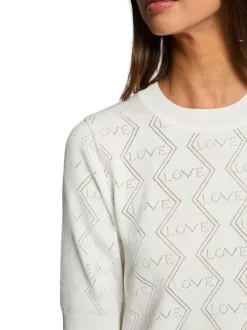 Pull blanc à motifs avec une coupe droite et des manches courtes