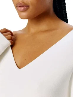 Pull blanc uni pourvu d'une coupe droite et de manches longues