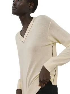 Pull écru uni en maille fine avec une coupe droite et un col v