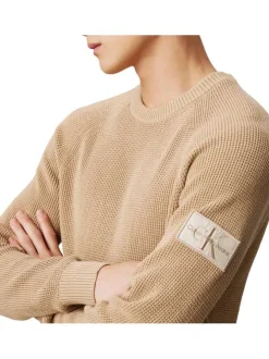 Pull en coton beige uni avec une coupe droite et nom iconique
