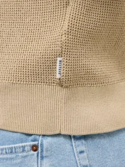 Pull en coton beige uni avec une coupe droite et un col rond