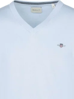 Pull en coton bleu ciel uni avec un col v et le logo brodé à la poitrine