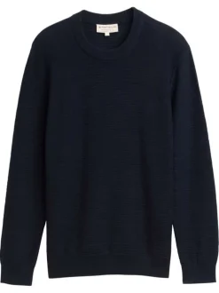 Pull en coton marine uni avec un col rond et des manches longues