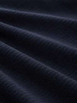 Pull en coton marine uni avec un col rond et des manches longues