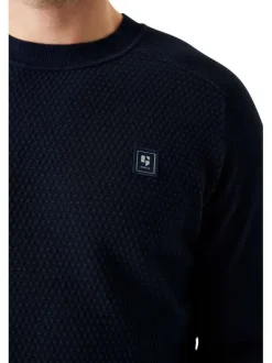 Pull en coton marine uni avec une coupe droite un col rond et un logo cousu