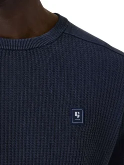 Pull en coton marine uni en maille tricotée avec patch de la marque
