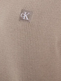 Pull en coton mauve uni avec logo iconique et une coupe droite à col v