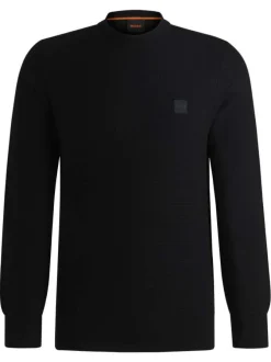 Pull en coton noir pourvu d'un col rond et de manches longues