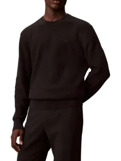 Pull en coton noir uni en maille avec un col rond et le mini logo brodé