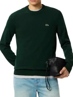 Pull en coton vert foncé avec un col rond et des manches longues
