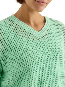 Pull en coton vert uni pourvu d'un cordon de serrage et de manches longues