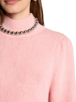 Pull rose uni pourvu d'un col montant et de manches longues