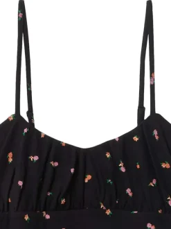Robe courte en coton noir fleurie avec une coupe droite et un col v