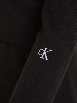 Robe courte noire avec une coupe slim fit un col rond et à manches longues