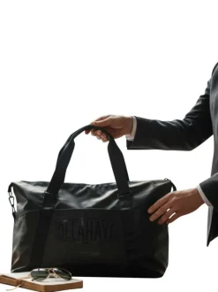 Sac weekender noir pourvu d'anses plates et d'une fermeture zippée