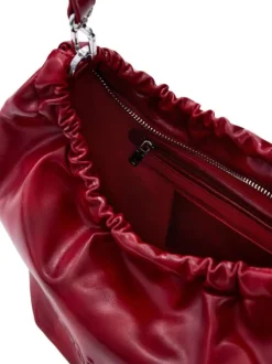 Sac bandouliere rouge uni pourvu d'une anse bicolore tressée