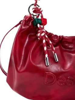 Sac bandouliere rouge uni pourvu d'une anse bicolore tressée