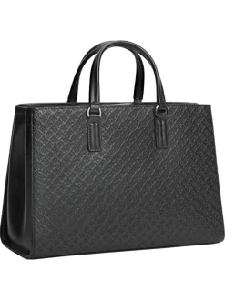 Sac à main noir pourvu d'une bandoulière amovible et de détails dorés