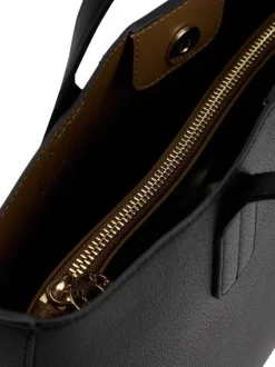 Sac à main noir pourvu d'une bandoulière amovible et d'un bouton à pression