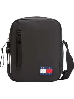 Sacoche noire unie avec un patch d'authenticité à l'avant et un zip