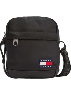 Sacoche noire unie une poche zippée à l'avant et logo iconique