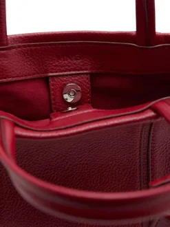 Sac porte mains rouge uni pourvu d'une bandoulière réglable