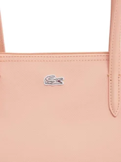 Sac shopping saumon pourvu d'une fermeture zippée et du logo de la marque