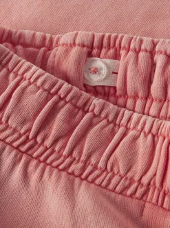 Short jogging en coton biologique corail uni pourvu d'une coupe droite